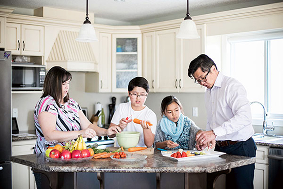 Family preparing meal in kitchen