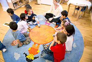 Children sitting in a circle with teacher