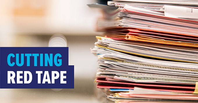 Photo of a stack of papers with text: Cutting red tape