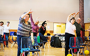 Seniors exercising in a recreation centre.