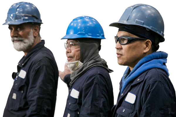 Photo of three workers at a steel manufacturing factory in Etobicoke, Ontario. 