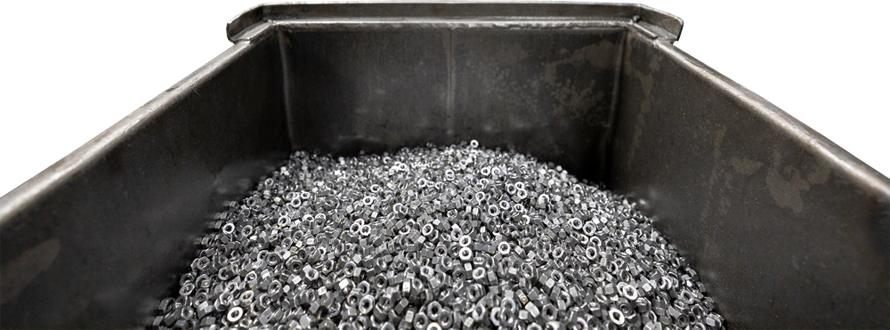 Photo of metal nuts in a bin at a factory in Scarborough, Ontario.