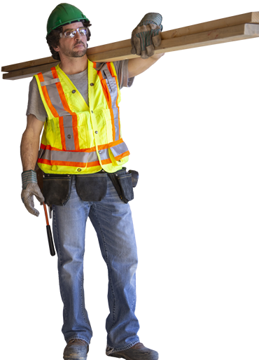 Photo of a construction worker carrying lumber.