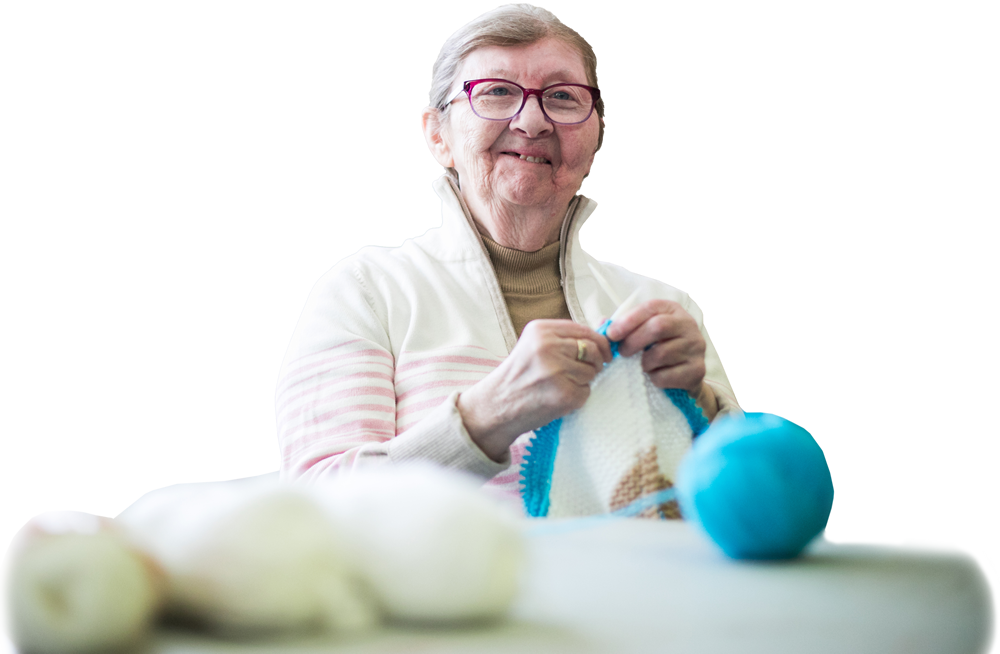 Photo of a senior participating in a knitting class at a seniors centre.