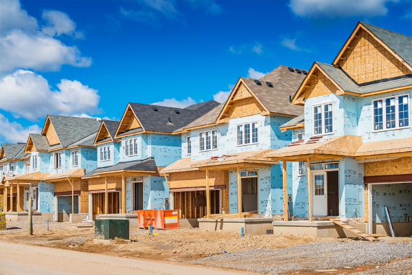Photo of new homes under construction in a residential community. 