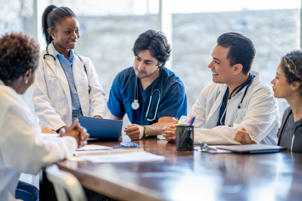 Photo of a group of medical students talking around a table.