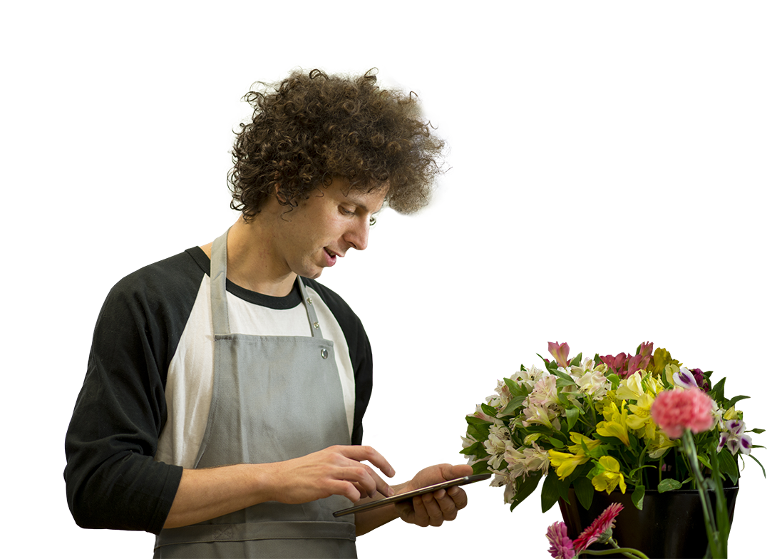 Photo of small business owner checking their orders in a flower shop.