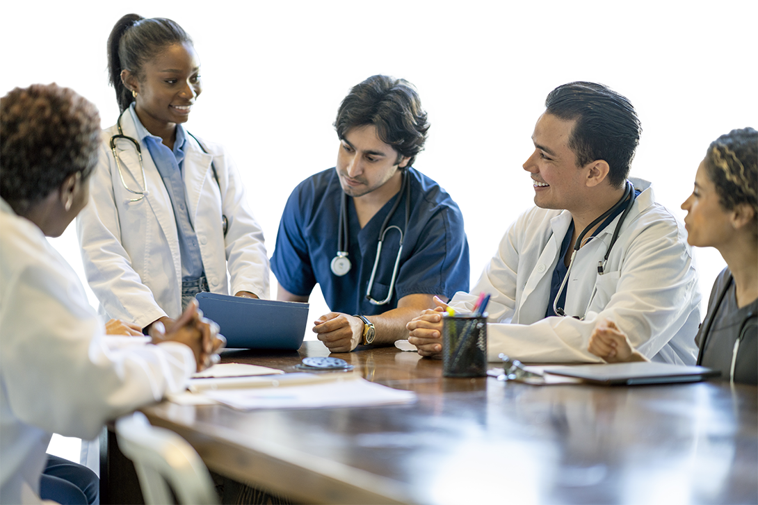 Photo of a group of medical students talking around a table.