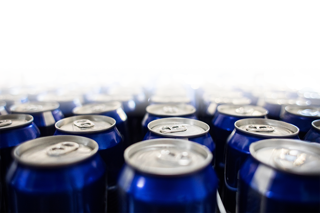 Photo of beer cans inside a fridge.