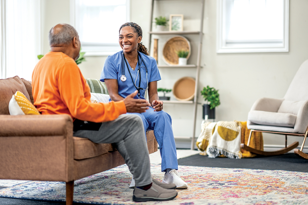 Photo of a home care nurse sitting with a senior.