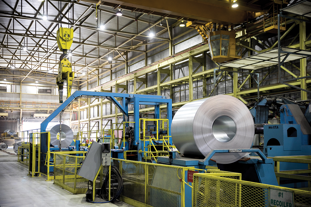 Photo of steel roll on a machine in a factory.