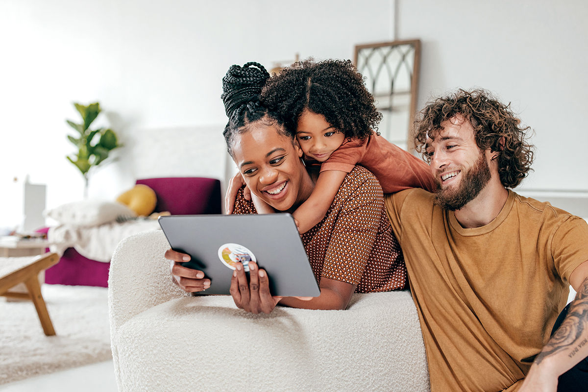 Young family watching online movie together on tablet