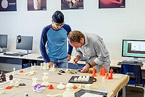 Student and teacher working on a model from 3D printing.