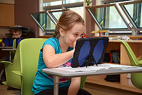 Child using her tablet.